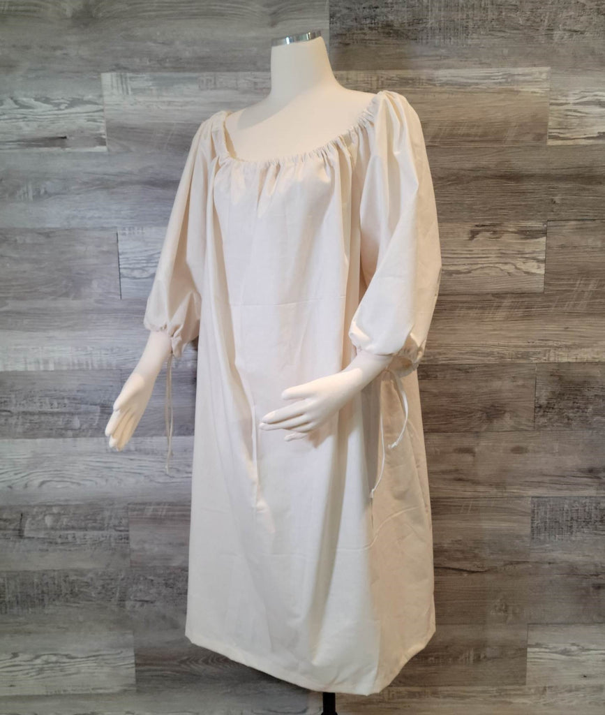 Off-white linen plainweave infant's chemise with drawstring neck